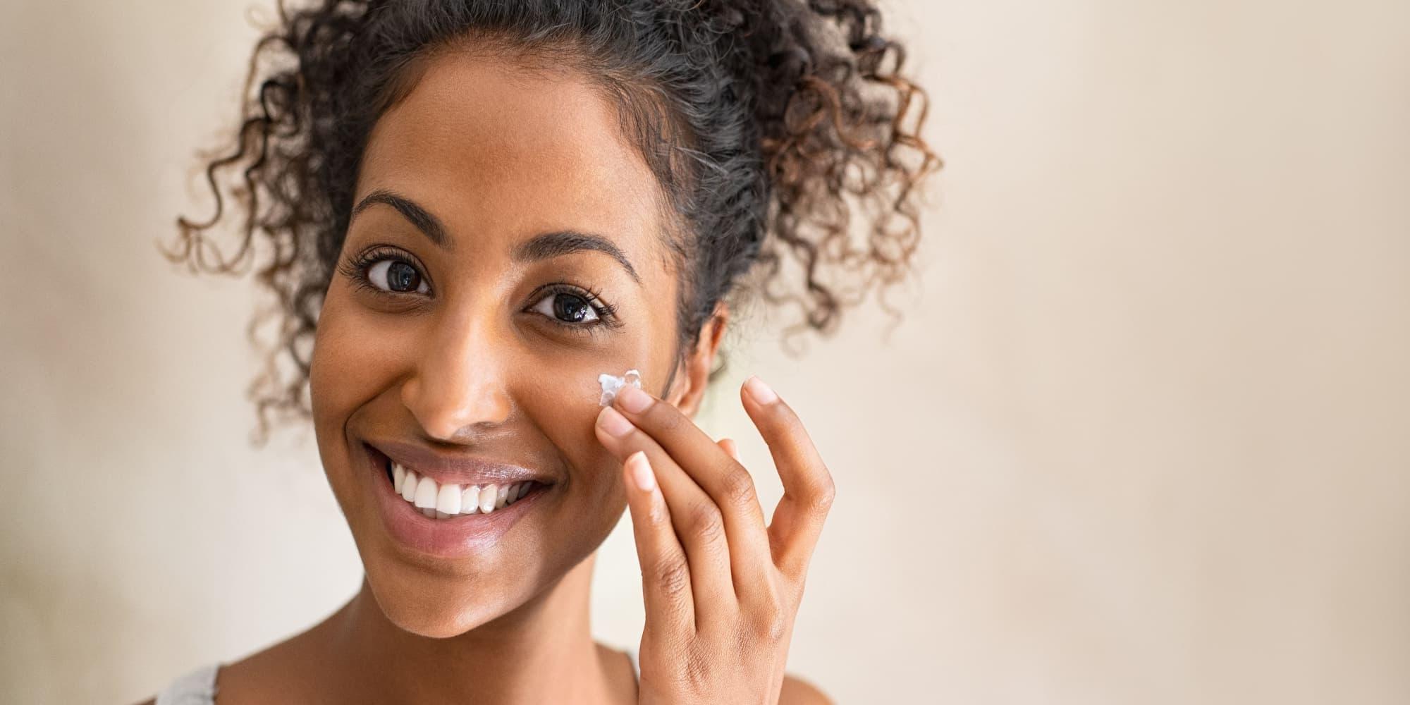 Model applies lotion with chemical products. 